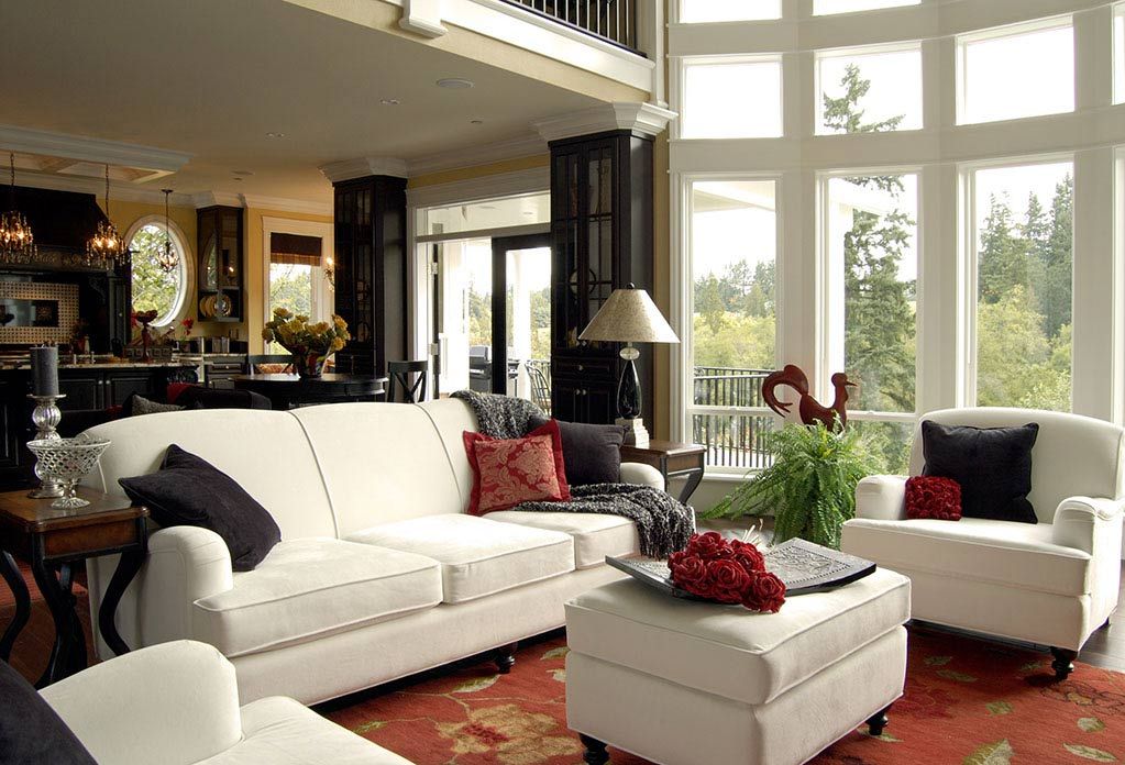 A living room with large windows, creating a functional entertaining space.