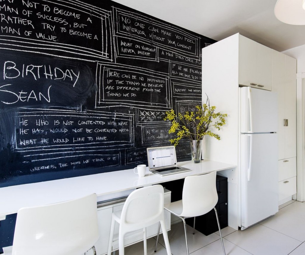 A kitchen with a creative chalkboard feature.