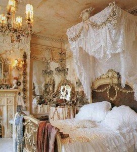 An ornate shabby chic bedroom with a canopy bed and chandelier.