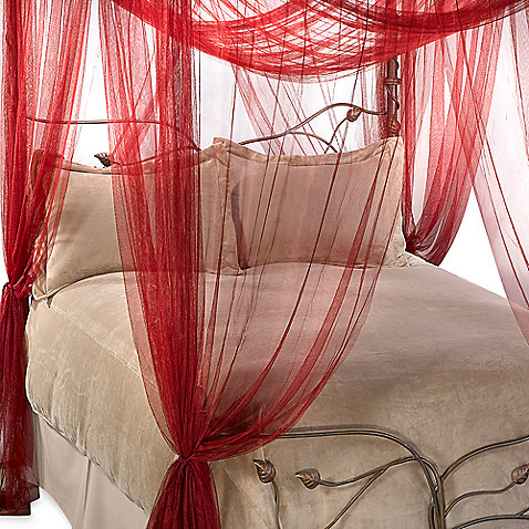 A romantic bedroom with a red canopy.