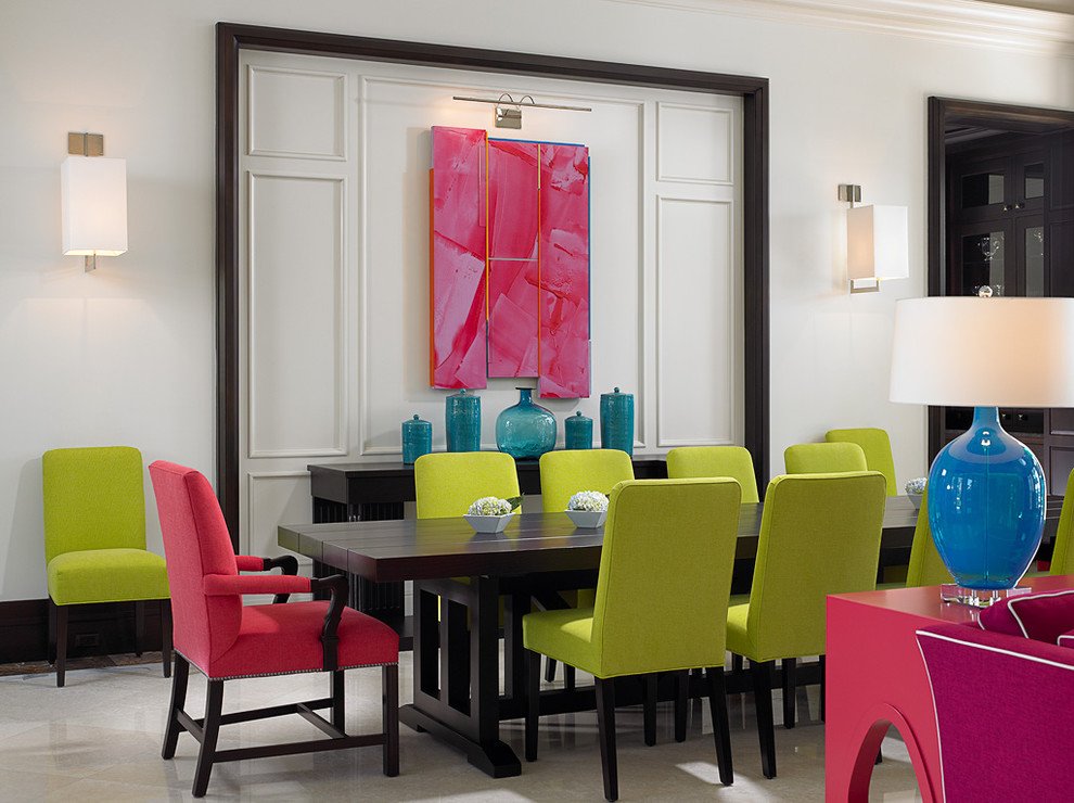 Brightly colored chairs in a bold dining room.