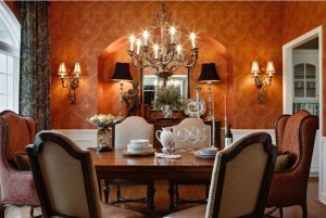 A formal dining room with bold orange walls.