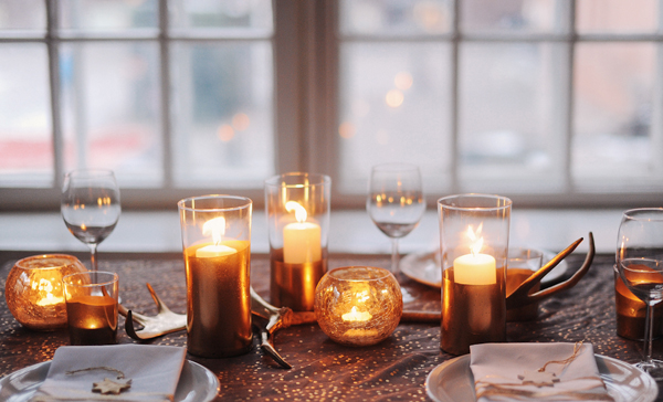 A table setting adorned with candles and napkins, perfect for a New Year's Eve party decoration.