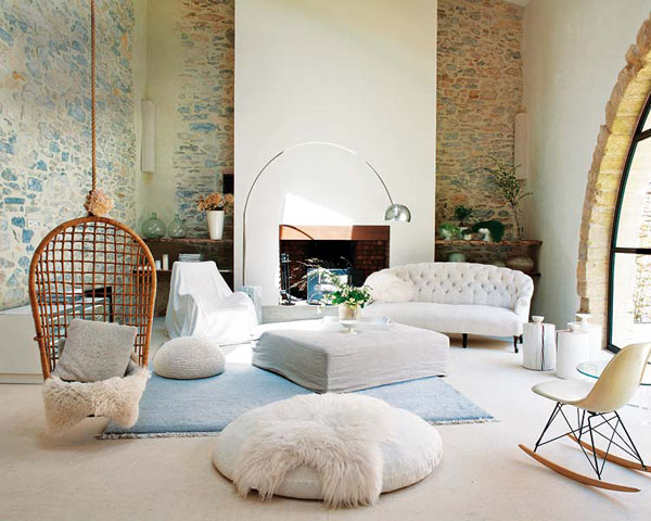 A living room with a white couch and a rocking chair, featuring indoor swings for every room.
