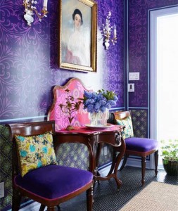 A hallway with bold purple walls and a statement purple chair.