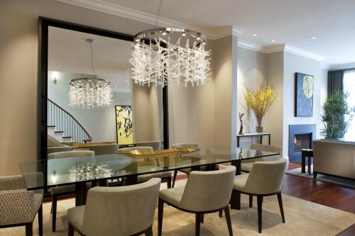 A dining room with a shimmering glass table.