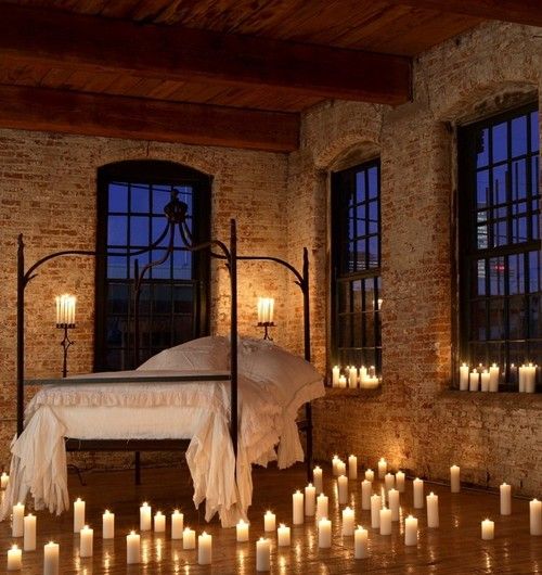 Creating a cozy bedroom ambiance with candles and a bed.