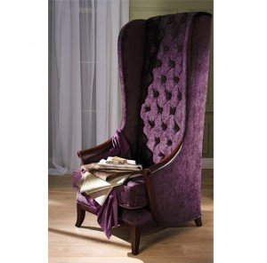 A purple velvet chair with a book on it.