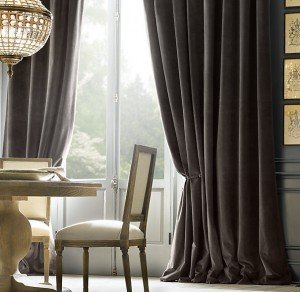 A dining room with a velvet tablecloth and chairs.