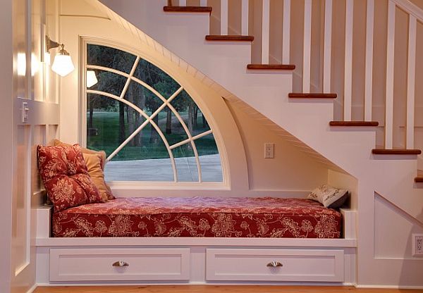 A bed under a window in a house.