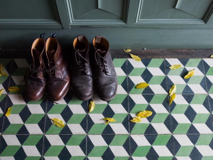 A pair of shoes on a tiled floor.