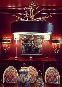 A marsala chandelier hanging over a dining room table.