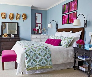 A bedroom with blue walls and pink accents, featuring top bedroom colors of 2015.