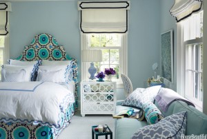 A blue and white bedroom with a bed.