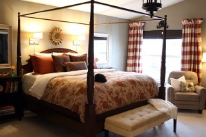 A bedroom with a four poster bed and a chair featuring top bedroom colors of 2015.
