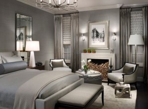 A bedroom with gray walls and a fireplace among the top bedroom colors of 2015.