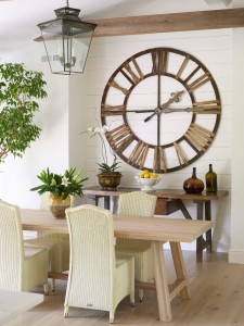 A clock on the wall in a dining room.