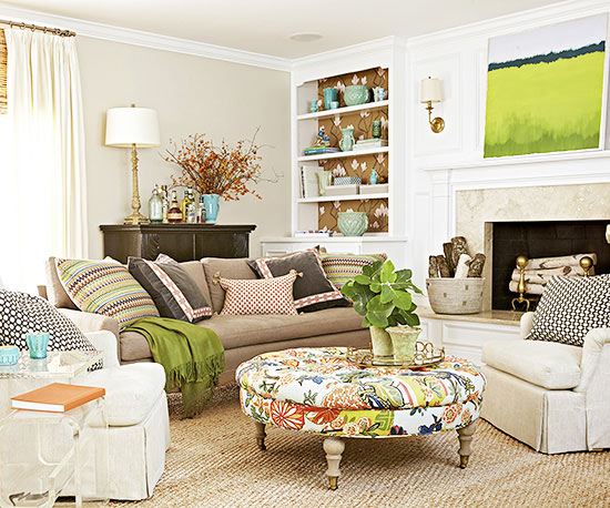 A living room with a fireplace and florals.