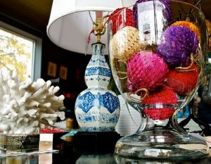A vase filled with colorful ornaments and a lamp on a table, showcasing texture.