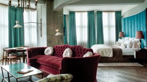 A room with a marsala-colored bed and couch.