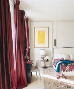 A bedroom with marsala curtains and a bed.
