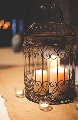 A table adorned with vintage birdcage candles.