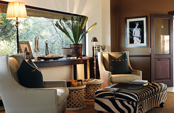 A living room with a global chic vibe featuring a zebra print rug.