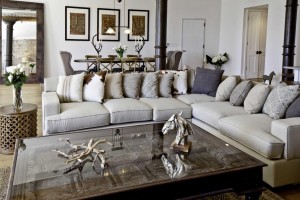 A living room with a white couch and gray interiors.