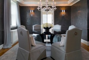 Gray walls and chandelier in a dining room with elegant gray interiors.
