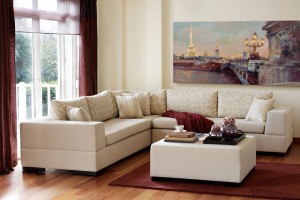 A sectional couch in a living room with marsala accents.