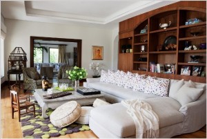 A living room with textured bookshelves and a white couch.