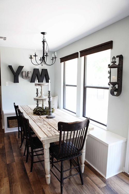 A wooden table and chairs in a dining room, embodying interior design trends for 2015.