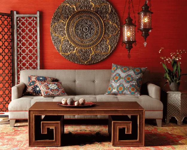 A living room with red walls and a global chic coffee table.