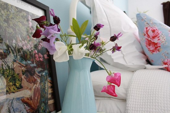 A flower arrangement on a bedside table.