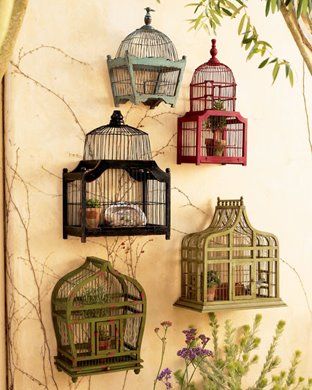 Vintage bird cages hung as wall decorations.