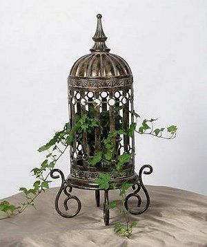 A vintage birdcage adorned with ivy.