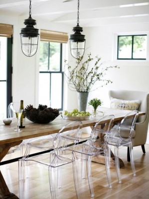 A dining room with clear chairs.