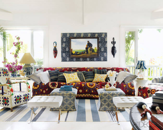 A living room with a colorful rug featuring global chic style.