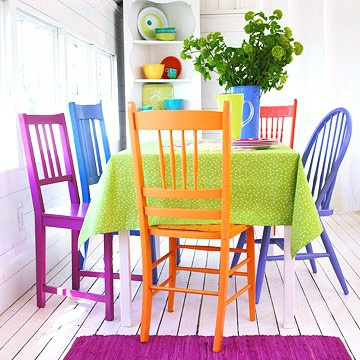 Brightly colored dining room chairs.