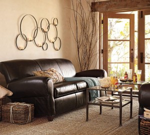 A living room with a leather couch and a textured coffee table.