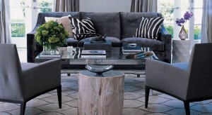 A living room with gray interiors and zebra print pillows.