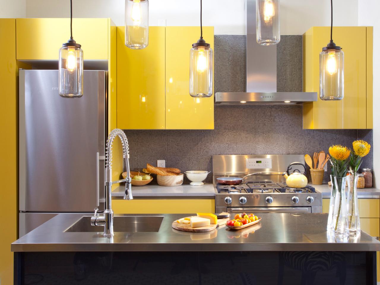 A kitchen with yellow cabinets and stainless steel appliances.