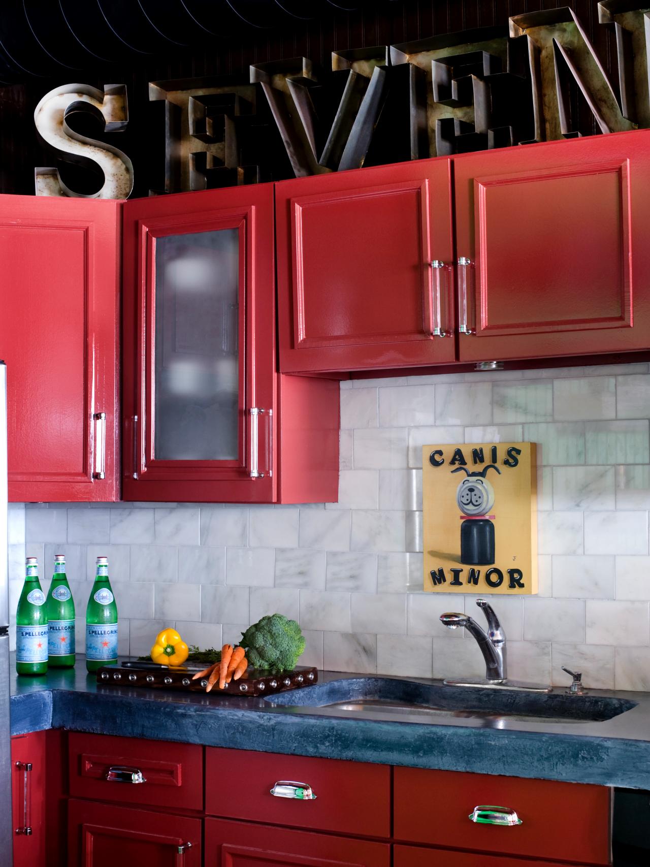 A kitchen with red cabinets.