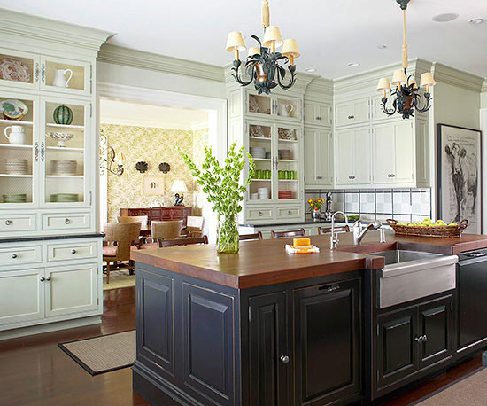 A black kitchen with cabinets and an island.