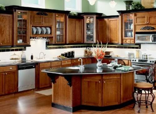 A kitchen with center island and wooden cabinets.