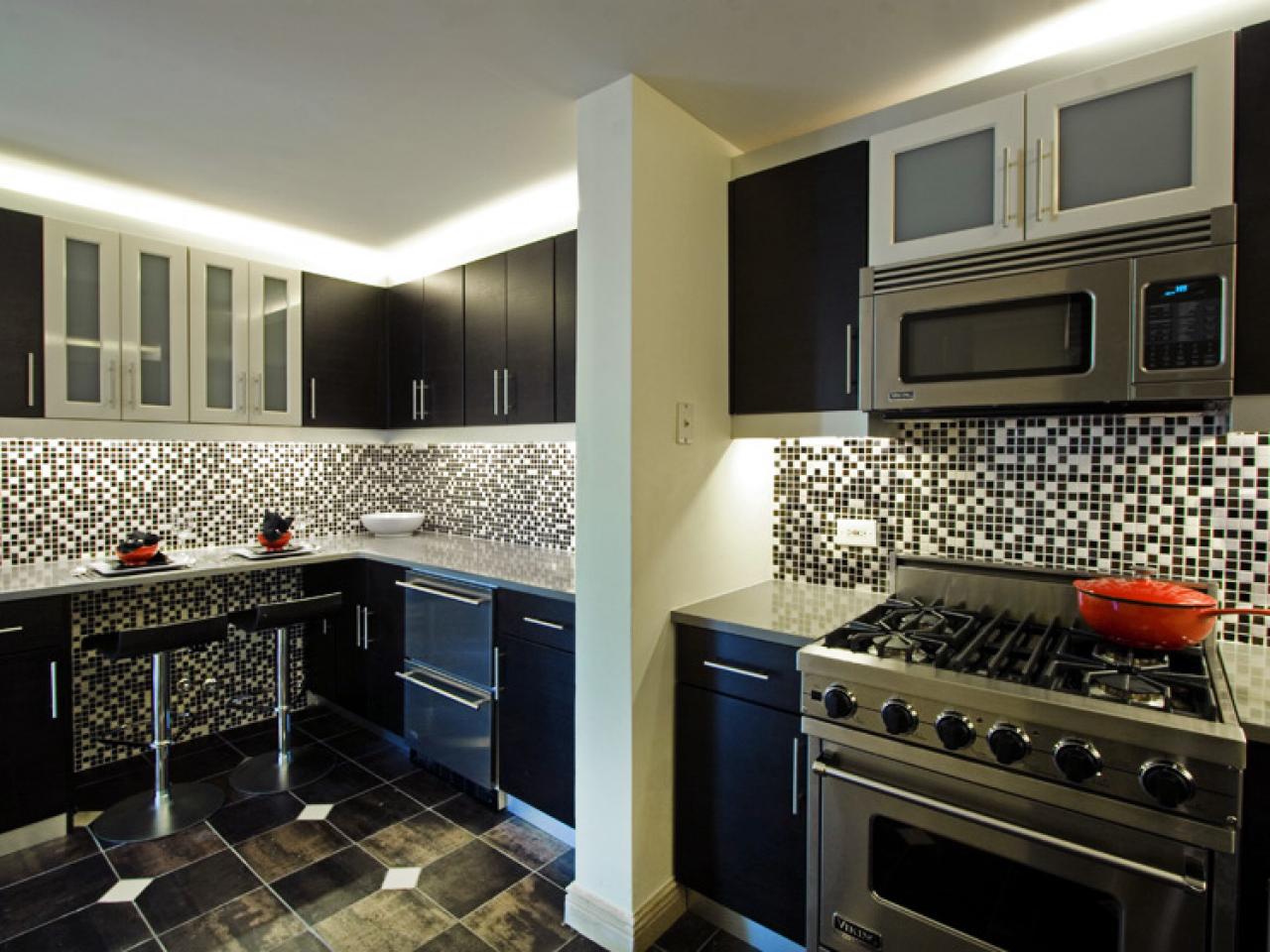 A black and white kitchen with kitchen cabinets and a stove.