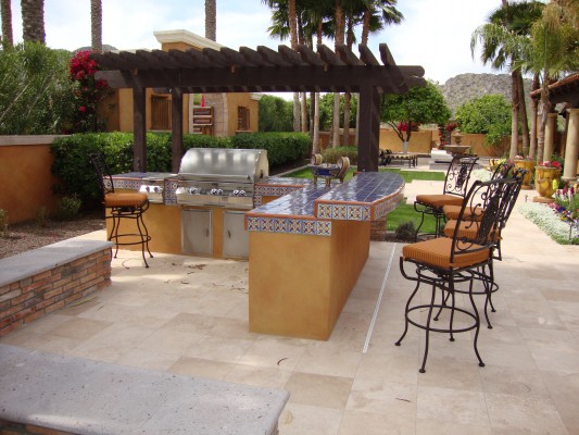 A bar area offers extra seating in this outdoor kitchen (Kitchen by Dream Retreats, AZ)