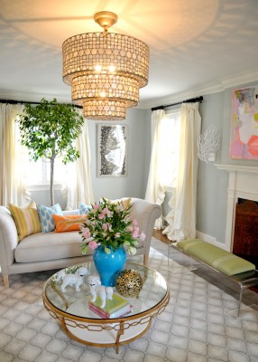 A spring-inspired living room with a chandelier and a coffee table.