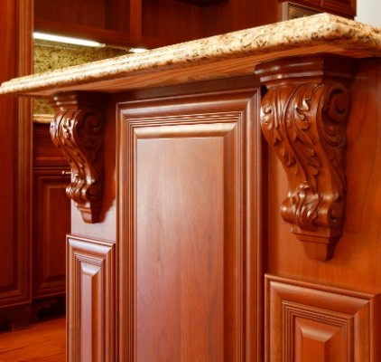 A traditional kitchen with wooden cabinets and a granite counter top.