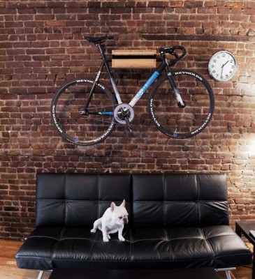 A bicycle hanging in a living room for storage.